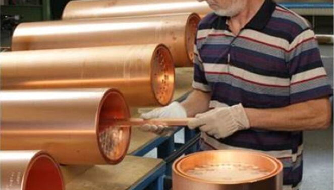 Employee with copper cladding tubes